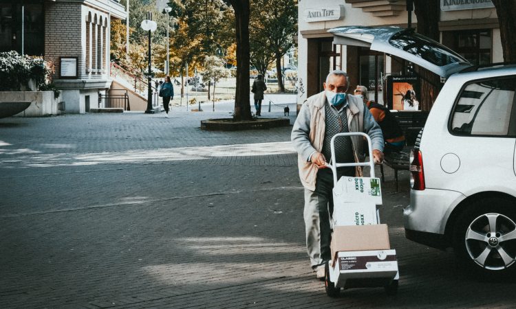 man pushing delivery cart