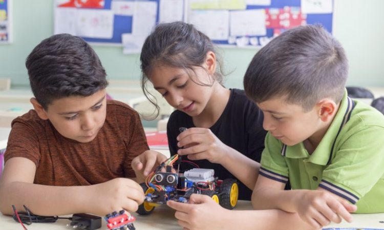 three kids in elementary school classroom