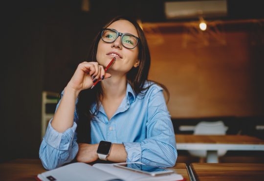 woman sitting at desk thinking