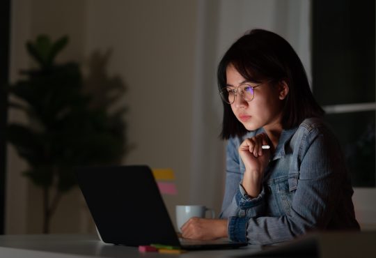 young woman working late at desk