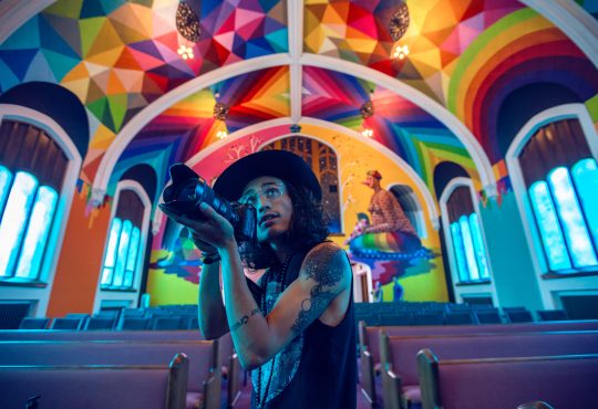 photographer inside colourful building