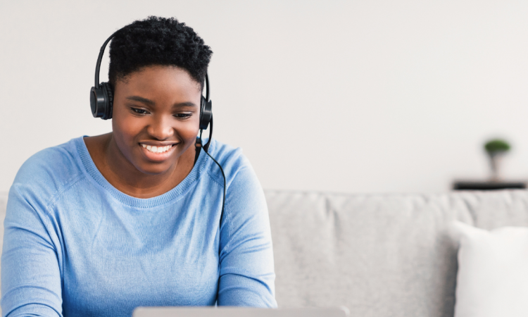 Woman wearing headphones using laptop