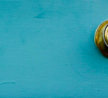 gold door handle on teal background