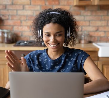 woman participating in video call on laptop