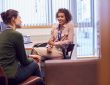 Female College Student Meeting With Campus Counselor