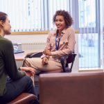 Female College Student Meeting With Campus Counselor