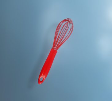red whisk on blue background