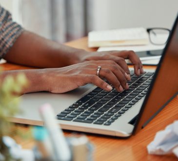 woman typing on laptop