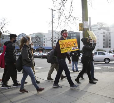 People march during the “We Are Not Silent” rally against anti-Asian hate in response to recent anti-Asian crime in the Chinatown-International District of Seattle, Washington on March 13, 2021.