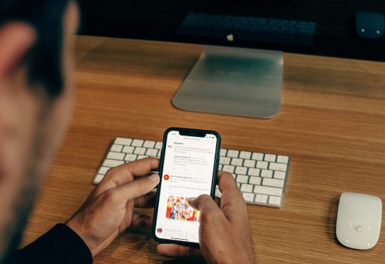 man scrolling through social media on cellphone