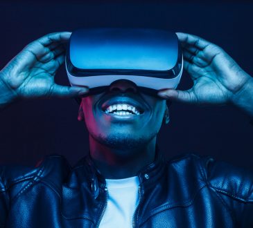 man smiling and wearing virtual reality headseat