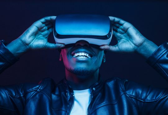 man smiling and wearing virtual reality headseat