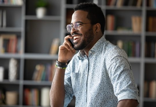 man having work phone call looking happy