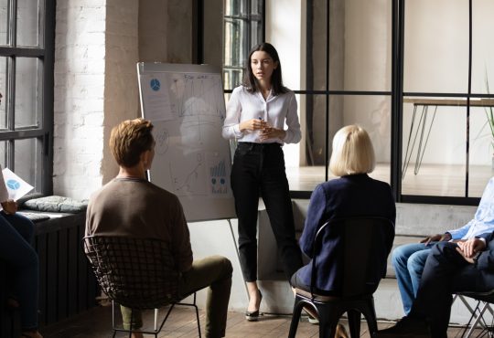 woman giving presentation to colleagues