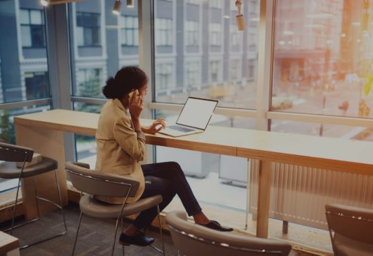 woman on laptop in coworking space