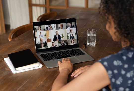 woman on video call at kitchen table