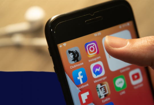 Clubhouse app among other social media icons on smartphone screen