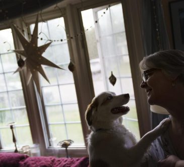 woman with dog in home