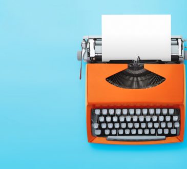 orange typewriter on blue background