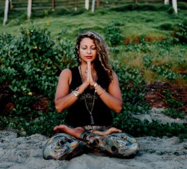 woman sitting in meditative pose outside