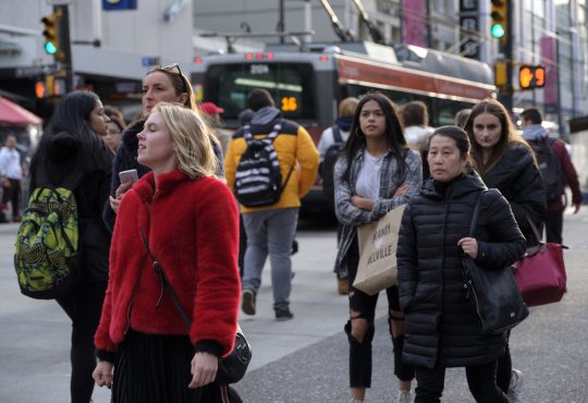 crowd walking on toronto street