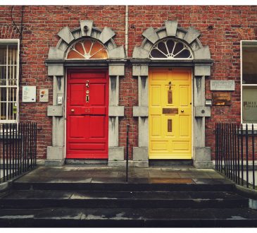 two differently coloured house front doors side by side