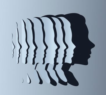 series of overlapping faces cut out of blue paper
