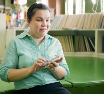 young blind woman using smart phone with voice accessibility