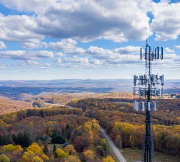 Aerial view of cell tower over forested rural area