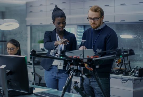 team of engineers working on drone project in laboratory