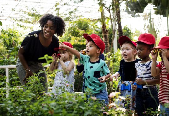 Teacher and kids learning gardening