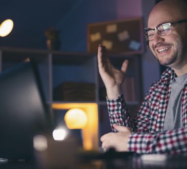 Man having a conference call using laptop computer.