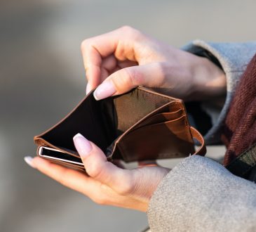 Woman holding empty wallet