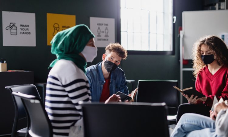 Men and women reading and talking in a circle during group therapy