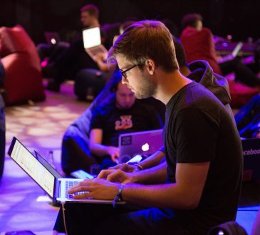 People working on laptops during hackathons.