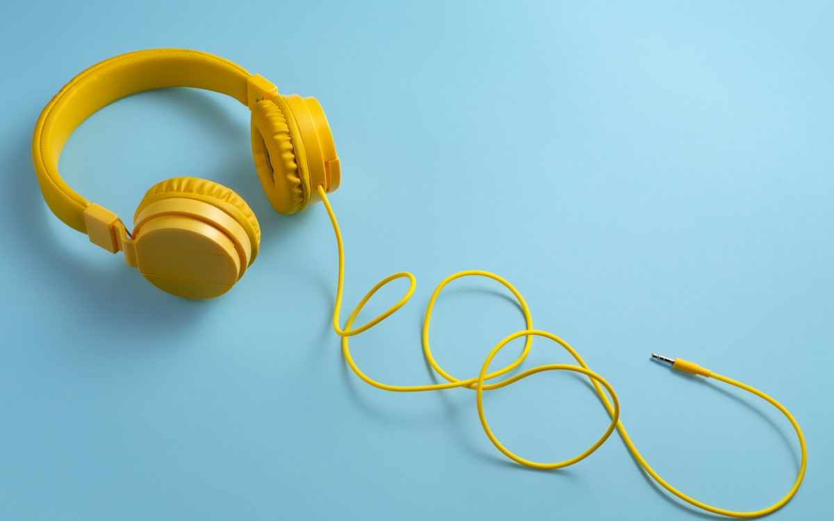 Yellow headphones on blue background.