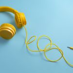 Yellow headphones on blue background.