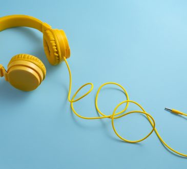 Yellow headphones on blue background.