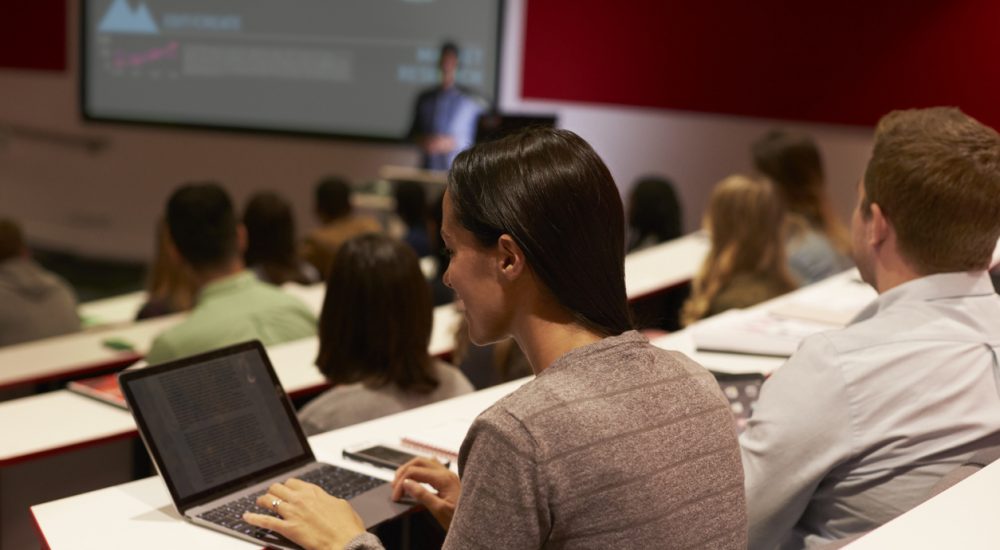 Adult student using laptop computer at a university lecture