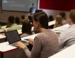Adult student using laptop computer at a university lecture