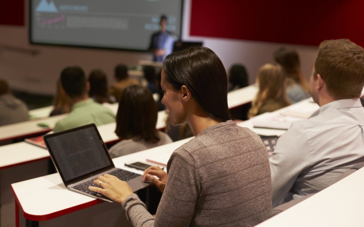 Adult student using laptop computer at a university lecture
