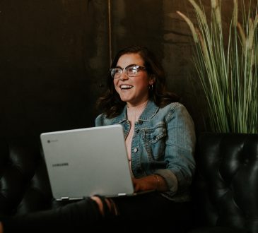 Smiling student using laptop