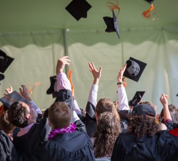 Students throw hats at graduation ceremony.