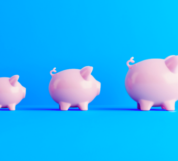 Three pink piggy banks on blue background