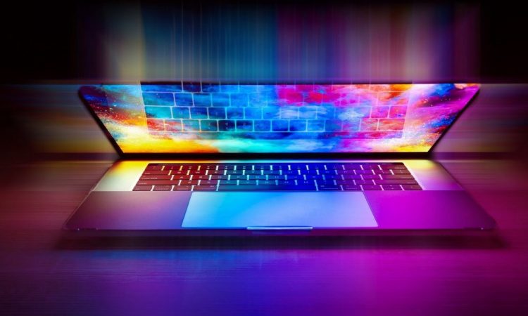 Colourful laptop screen glowing in dark