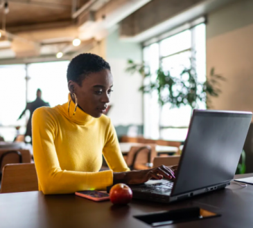 Black woman working on laptop in office