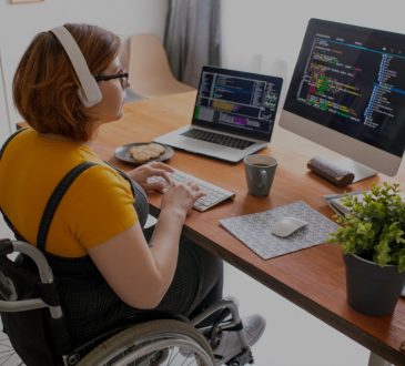 Woman working at computer in wheelchair