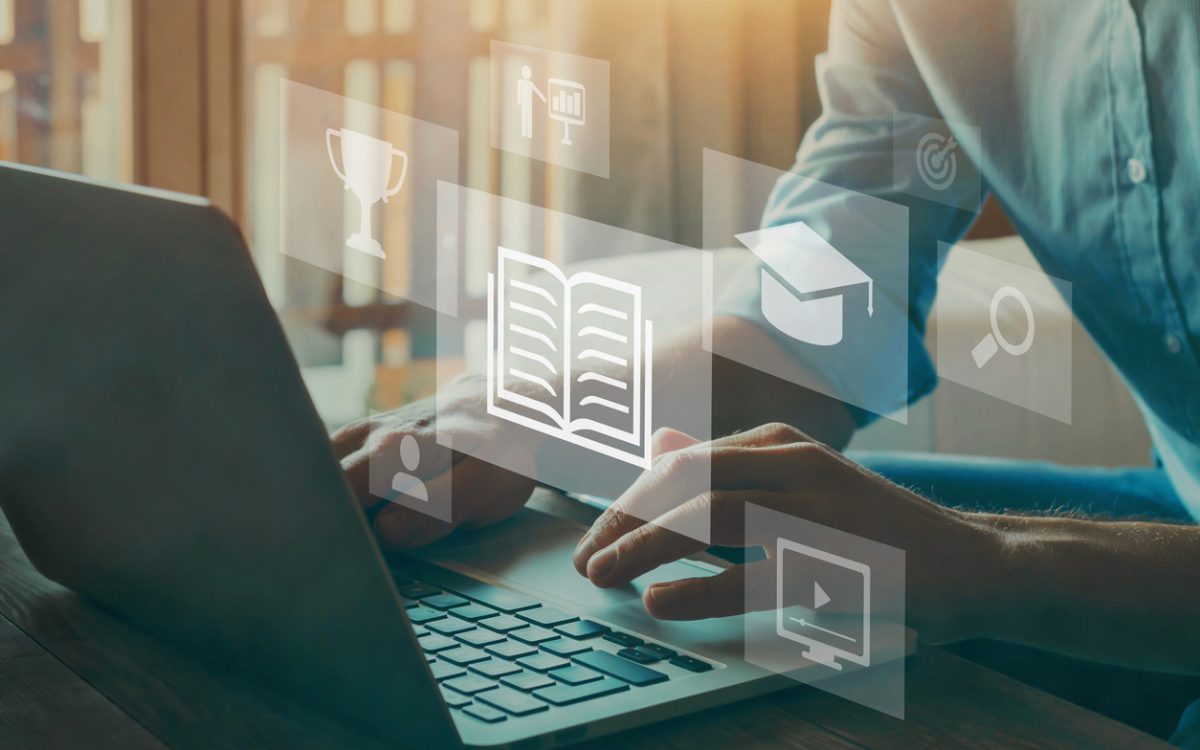 Person typing on computer overlaid with icons representing e-learning