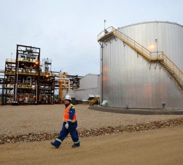 An oilfield worker walks past the Statoil oil sands facility near Conklin, Alberta.