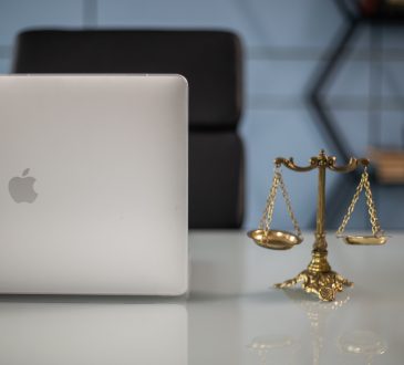 Scales of justice beside laptop